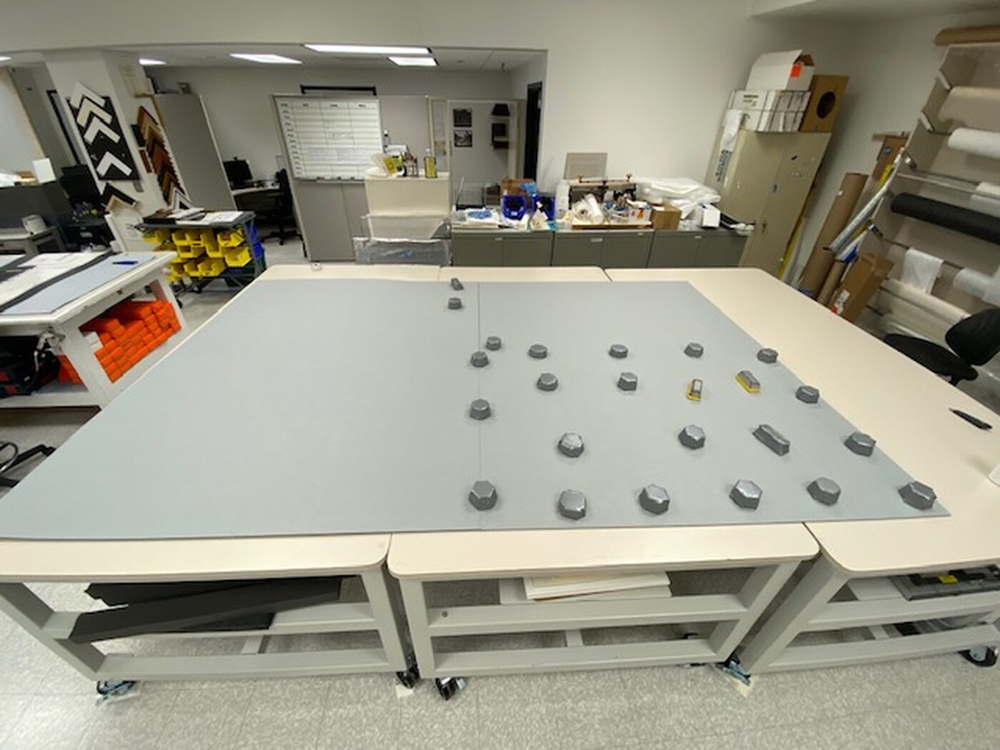 Weights hold down the blueboard during lamination.